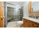 Well-appointed bathroom with a tiled shower, granite countertop, and wooden vanity at 355 Clark Creek Pass, Acworth, GA 30102