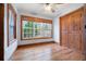 This bedroom features wood trim and floors, a window and a ceiling fan at 355 Clark Creek Pass, Acworth, GA 30102