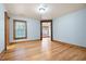 Bright bedroom featuring wood floors, natural trim, a large window, and ample space at 355 Clark Creek Pass, Acworth, GA 30102