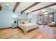 Light-filled main bedroom featuring exposed beams, a sitting area, and light blue walls at 355 Clark Creek Pass, Acworth, GA 30102