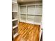 Spacious walk-in closet with custom shelving and hardwood floors for optimal organization at 355 Clark Creek Pass, Acworth, GA 30102