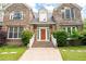 Stone home showcasing a grand entrance with detailed stonework, landscaping, and covered porch at 355 Clark Creek Pass, Acworth, GA 30102