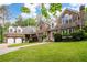 Charming stone home with a well-manicured lawn, two-car garage, and inviting entryway at 355 Clark Creek Pass, Acworth, GA 30102