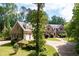 Handsome stone house with well-kept front yard, driveway, and garage in a wooded setting at 355 Clark Creek Pass, Acworth, GA 30102