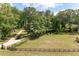 Charming home with a long driveway, fenced yard, and mature trees at 355 Clark Creek Pass, Acworth, GA 30102