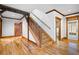 Hallway with wood accents, hardwood flooring, and natural light streaming through the nearby doorway at 355 Clark Creek Pass, Acworth, GA 30102