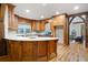 Kitchen showcasing custom wood cabinets, wood flooring, granite countertops, and modern appliances at 355 Clark Creek Pass, Acworth, GA 30102