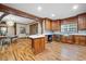 Kitchen with custom wood cabinets, wood flooring, stainless steel appliances, and breakfast area at 355 Clark Creek Pass, Acworth, GA 30102