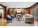 Cozy living room featuring detailed wood trim, fireplace, and comfortable seating area at 355 Clark Creek Pass, Acworth, GA 30102