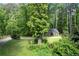 Charming outbuilding nestled among mature trees, offering privacy and functionality at 355 Clark Creek Pass, Acworth, GA 30102