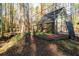 Outbuilding with batting cage, set among mature trees and lush greenery at 355 Clark Creek Pass, Acworth, GA 30102