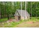 Stone outbuilding with a gable roof and a covered area for outdoor activities at 355 Clark Creek Pass, Acworth, GA 30102