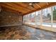 Covered patio boasts stone accent wall, ceiling fans, and views of the backyard swimming pool at 355 Clark Creek Pass, Acworth, GA 30102