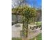 Enchanting backyard pergola with climbing yellow flowers, fire pit, and inviting swing at 355 Clark Creek Pass, Acworth, GA 30102