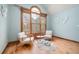 Bright sitting room with large windows, light blue walls, hardwood flooring, and modern decor at 355 Clark Creek Pass, Acworth, GA 30102