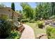 Serene backyard featuring a brick pathway, swing, and cultivated garden plots, creating a peaceful outdoor oasis at 4390 Wicklow Ct, Suwanee, GA 30024