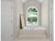 Relaxing bathroom with a soaking tub, arched windows, and natural light at 4390 Wicklow Ct, Suwanee, GA 30024