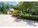 Inviting home featuring a long driveway, manicured landscaping, and mature trees, enhancing the property's charm at 4390 Wicklow Ct, Suwanee, GA 30024