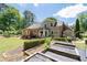 Expansive backyard with a covered patio and well-maintained garden beds showcasing the home's outdoor living spaces at 4390 Wicklow Ct, Suwanee, GA 30024
