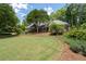 Beautiful home with a large, manicured front yard, mature trees, and tasteful landscaping, offering curb appeal at 4390 Wicklow Ct, Suwanee, GA 30024