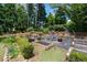 Extensive backyard featuring raised garden beds and mature trees, ideal for gardening and outdoor enjoyment at 4390 Wicklow Ct, Suwanee, GA 30024