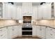 Well-appointed kitchen with stainless steel appliances, custom cabinetry, and a tile backsplash at 4390 Wicklow Ct, Suwanee, GA 30024
