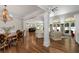 Spacious open-concept living room with hardwood floors, large windows, and seamless flow to the kitchen and dining areas at 4390 Wicklow Ct, Suwanee, GA 30024