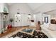 Inviting living room featuring vaulted ceilings, built-in shelving, an area rug and hardwood floors at 4390 Wicklow Ct, Suwanee, GA 30024