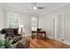 Home office with hardwood floors, plantation shutters, and a leather chair and ottoman set at 4390 Wicklow Ct, Suwanee, GA 30024