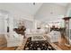 Bright open-concept living room featuring hardwood floors, vaulted ceilings, comfortable seating, and seamless flow to other rooms at 4390 Wicklow Ct, Suwanee, GA 30024