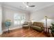 Cozy living room featuring hardwood floors, a globe, a tufted sofa, and shuttered windows at 4390 Wicklow Ct, Suwanee, GA 30024