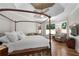 Serene primary bedroom with hardwood floors, tray ceiling, and a sitting area at 4390 Wicklow Ct, Suwanee, GA 30024