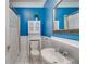 Stylish bathroom with blue walls, vanity sink, and white cabinet storage at 959 Hall Nw Pl, Atlanta, GA 30318