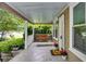 Inviting covered front porch with swing, complemented by potted plants at 959 Hall Nw Pl, Atlanta, GA 30318
