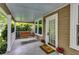 Charming covered front porch with swing, complemented by potted plants at 959 Hall Nw Pl, Atlanta, GA 30318