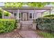 Charming front porch with swing, potted plants, and inviting curb appeal at 959 Hall Nw Pl, Atlanta, GA 30318