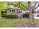 Home exterior featuring a well-maintained yard with mature tree and manicured bushes at 959 Hall Nw Pl, Atlanta, GA 30318