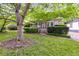 Inviting home with lush green lawn and mature shade tree in the front yard at 959 Hall Nw Pl, Atlanta, GA 30318