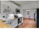 Bright kitchen with white cabinetry, butcher block countertops, and stainless steel appliances at 959 Hall Nw Pl, Atlanta, GA 30318
