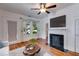 Bright living room with fireplace, hardwood floors, ceiling fan, and large window at 959 Hall Nw Pl, Atlanta, GA 30318