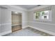 A cozy room that features carpet, a window with an attractive shade, and white trim throughout at 959 Hall Nw Pl, Atlanta, GA 30318