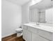 Bright bathroom featuring a white vanity, modern sink and wood-look flooring at 132 2Nd Nw St, Atlanta, GA 30318