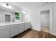 Bright bathroom with double vanity, wood-look floors, and natural light at 132 2Nd Nw St, Atlanta, GA 30318