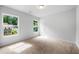 Carpeted bedroom featuring a double window view and natural light at 132 2Nd Nw St, Atlanta, GA 30318