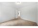 Carpeted bedroom with white walls, simple ceiling light and an open doorway at 132 2Nd Nw St, Atlanta, GA 30318