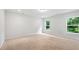 Large bedroom with neutral carpet and exterior view from two windows at 132 2Nd Nw St, Atlanta, GA 30318
