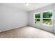 Bright bedroom with carpet, two windows, and an exterior view at 132 2Nd Nw St, Atlanta, GA 30318