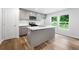 Stylish kitchen featuring gray cabinets, quartz countertops, and a central island at 132 2Nd Nw St, Atlanta, GA 30318