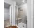 Modern tiled shower with built-in bench and glass door at 132 2Nd Nw St, Atlanta, GA 30318