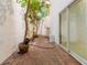 View of courtyard with brick flooring, plants, and sliding glass doors to the interior at 165 River North Walk, Atlanta, GA 30328
